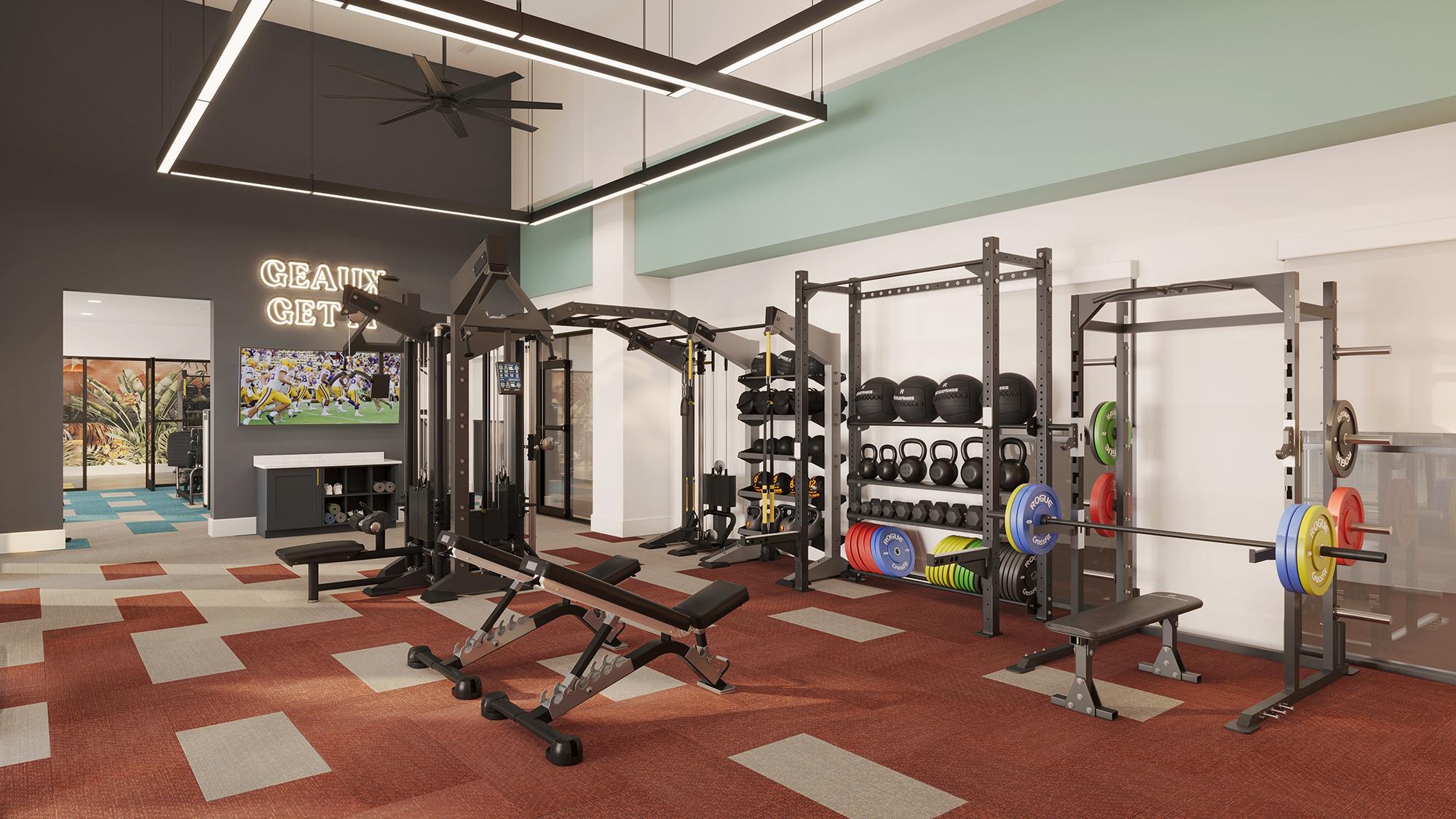 Sterling Tiger Valley Modern gym with strength training equipment, weights, benches, kettlebells, and a TV on the wall. "Grind Get Fit" sign in the background.