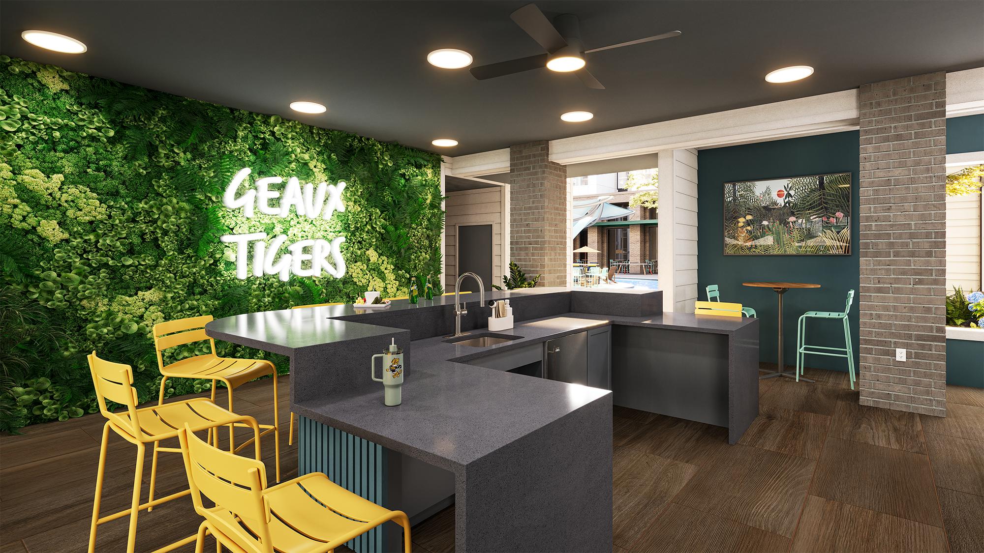 Sterling Tiger Valley Modern lounge with a plant wall, neon "Geaux Tigers" sign, yellow barstools, and a view of a pool through large windows.