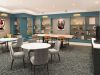 Sterling Tiger Valley Modern lounge with round tables, gray chairs, bookshelves, wall art, a TV, and built-in wooden desk in a brightly lit room.