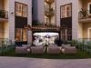 Sterling Tiger Valley Outdoor courtyard with lounge chairs facing a large screen showing a football game, surrounded by apartment balconies.